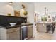 Stylish wet bar area with elegant countertop, bar refrigerator, and ample storage solutions, ideal for entertaining guests at 7432 E Holly St, Scottsdale, AZ 85257
