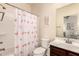 Bathroom featuring a flamingo shower curtain, a white toilet, and a dark wood vanity at 7726 E Baseline Rd # 154, Mesa, AZ 85209