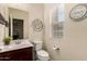 Cozy half bathroom with a single sink vanity, decor and natural light at 7726 E Baseline Rd # 154, Mesa, AZ 85209