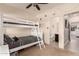 Bedroom featuring a bunk bed with black and white striped linens, a ceiling fan, and an ensuite bathroom at 7726 E Baseline Rd # 154, Mesa, AZ 85209