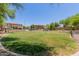 Expansive grassy common area with community features in the background at 7726 E Baseline Rd # 154, Mesa, AZ 85209