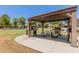 Community barbecue area with tables and multiple grills at 7726 E Baseline Rd # 154, Mesa, AZ 85209