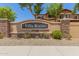 Attractive Villa Rialto community sign with stone accents and lush landscaping at 7726 E Baseline Rd # 154, Mesa, AZ 85209