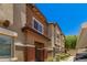 Attractive townhome exterior with stone detail and manicured landscaping at 7726 E Baseline Rd # 154, Mesa, AZ 85209