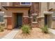 Attractive townhome exterior with stone detail and landscaping at 7726 E Baseline Rd # 154, Mesa, AZ 85209