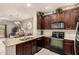 Bright kitchen with breakfast bar, black appliances, and views into the dining area at 7726 E Baseline Rd # 154, Mesa, AZ 85209