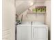 Laundry room featuring a washer and dryer, open shelving with storage baskets, and a light at 7726 E Baseline Rd # 154, Mesa, AZ 85209
