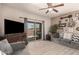 Relaxing living area with tile floors, sliding door to the backyard and a ceiling fan at 7726 E Baseline Rd # 154, Mesa, AZ 85209