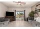 Well decorated living room with tile floors, access to patio and comfortable seating at 7726 E Baseline Rd # 154, Mesa, AZ 85209