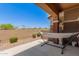 Covered patio featuring a hammock, columns, desert landscaping, and a privacy wall at 7726 E Baseline Rd # 154, Mesa, AZ 85209