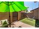 Private backyard with a green umbrella, hammock, artificial turf, and a block fence for privacy at 8532 E Portland St, Scottsdale, AZ 85257