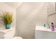 Cozy bathroom featuring a modern vanity, toilet, and neutral-toned brick wall at 8532 E Portland St, Scottsdale, AZ 85257