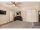 Bedroom featuring a ceiling fan, closet, and a dark dresser with a mirror at 8532 E Portland St, Scottsdale, AZ 85257