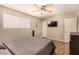 Comfortable bedroom includes a ceiling fan, a window, and a wall-mounted television at 8532 E Portland St, Scottsdale, AZ 85257