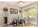 Bright dining area with modern table, slider access to patio and a stylish accent wall at 8532 E Portland St, Scottsdale, AZ 85257