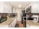 Modern kitchen with stainless steel appliances, granite countertops, and plenty of storage space at 8532 E Portland St, Scottsdale, AZ 85257
