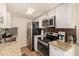 Well-equipped kitchen featuring stainless steel appliances, modern cabinetry, and ample counter space at 8532 E Portland St, Scottsdale, AZ 85257