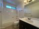 Bathroom showcasing a shower-tub combo and a modern sink with a sleek vanity at 9402 N 48Th Dr, Glendale, AZ 85302