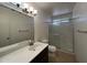 Bathroom featuring a single vanity, a large mirror, and a shower with glass doors at 9402 N 48Th Dr, Glendale, AZ 85302