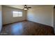 Bedroom featuring hard wood floors, a ceiling fan, and a view to the exterior of the property at 9402 N 48Th Dr, Glendale, AZ 85302