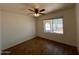 Bedroom featuring hard wood floors, a ceiling fan, and a window view to the exterior of the property at 9402 N 48Th Dr, Glendale, AZ 85302