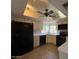 Eat-in kitchen featuring tile floor, white cabinetry, and modern black appliances at 9402 N 48Th Dr, Glendale, AZ 85302