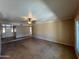 Open-concept living room with tile flooring, ceiling fan, and a bright airy feel at 9402 N 48Th Dr, Glendale, AZ 85302