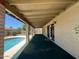 View of the covered outdoor patio area overlooking the sparkling pool at 9402 N 48Th Dr, Glendale, AZ 85302