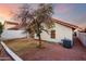 Exterior backyard view of the property showcasing a tree, and landscape rocks at 11358 E Jenan Dr, Scottsdale, AZ 85259