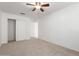 Bedroom with neutral carpet, white walls, ceiling fan, closet, and ample natural light at 11358 E Jenan Dr, Scottsdale, AZ 85259