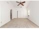 Bedroom featuring a ceiling fan, arched entryway, carpet flooring, and ample natural light at 11358 E Jenan Dr, Scottsdale, AZ 85259