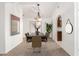 Staged dining room featuring vaulted ceilings, a modern chandelier, and ample natural light at 11358 E Jenan Dr, Scottsdale, AZ 85259