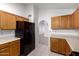 The kitchen has wooden cabinets, tile flooring, and modern appliances at 11358 E Jenan Dr, Scottsdale, AZ 85259
