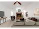 Staged living room featuring a brick fireplace, plush sofas, and plenty of space at 11358 E Jenan Dr, Scottsdale, AZ 85259