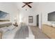 This staged primary bedroom includes neutral tones, a ceiling fan, and a dresser at 11358 E Jenan Dr, Scottsdale, AZ 85259