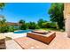 Backyard showcasing pool, spa, mature trees, and lush landscaping, creating a private oasis at 119 E Palomino Dr, Tempe, AZ 85284