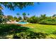 Expansive backyard showcasing a swimming pool, mature trees, and a well-manicured lawn at 119 E Palomino Dr, Tempe, AZ 85284