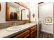 Bathroom with a dual-sink vanity, classic wooden cabinets, and decorative tile accents at 119 E Palomino Dr, Tempe, AZ 85284