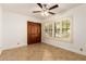 This bedroom offers tile flooring, a ceiling fan, and bright natural light at 119 E Palomino Dr, Tempe, AZ 85284