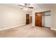 Open bedroom with carpeted floors, ceiling fan, and doors to the hallway and closet at 119 E Palomino Dr, Tempe, AZ 85284