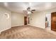 Spacious bedroom features neutral carpeting and a ceiling fan for added comfort at 119 E Palomino Dr, Tempe, AZ 85284