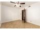 Bright bedroom boasts tile floors, a ceiling fan, and easy access to other rooms at 119 E Palomino Dr, Tempe, AZ 85284