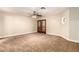 Spacious bedroom with neutral carpet, a ceiling fan, and double doors at 119 E Palomino Dr, Tempe, AZ 85284