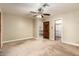 Open bedroom with ceiling fan, walk-in closet, and doors to the hallway and other rooms at 119 E Palomino Dr, Tempe, AZ 85284