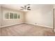 Cozy bedroom with neutral carpet features a ceiling fan and natural light at 119 E Palomino Dr, Tempe, AZ 85284