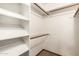 Walk-in closet with installed shelving and a clothing rod for optimal storage and organization at 119 E Palomino Dr, Tempe, AZ 85284