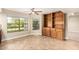 Bright dining area featuring tile floors, a ceiling fan, built-in storage, and natural light from two windows at 119 E Palomino Dr, Tempe, AZ 85284