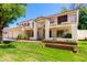 Beautiful two-story house featuring a three-car garage, lush lawn, and mature shade trees at 119 E Palomino Dr, Tempe, AZ 85284