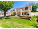 Gorgeous two-story house with a Spanish tile roof, balcony, and lush front lawn with mature trees at 119 E Palomino Dr, Tempe, AZ 85284