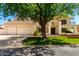Attractive two-story house featuring white stucco, a Spanish tile roof, and a large front yard tree at 119 E Palomino Dr, Tempe, AZ 85284